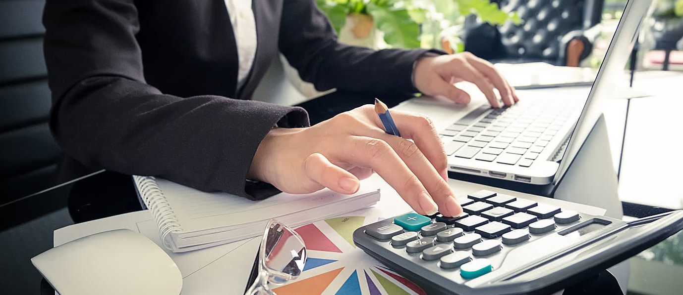 Accounting professional working with a calculator and records