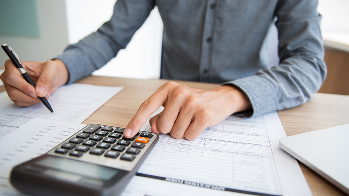 Calculator and worksheets used to organize business figures