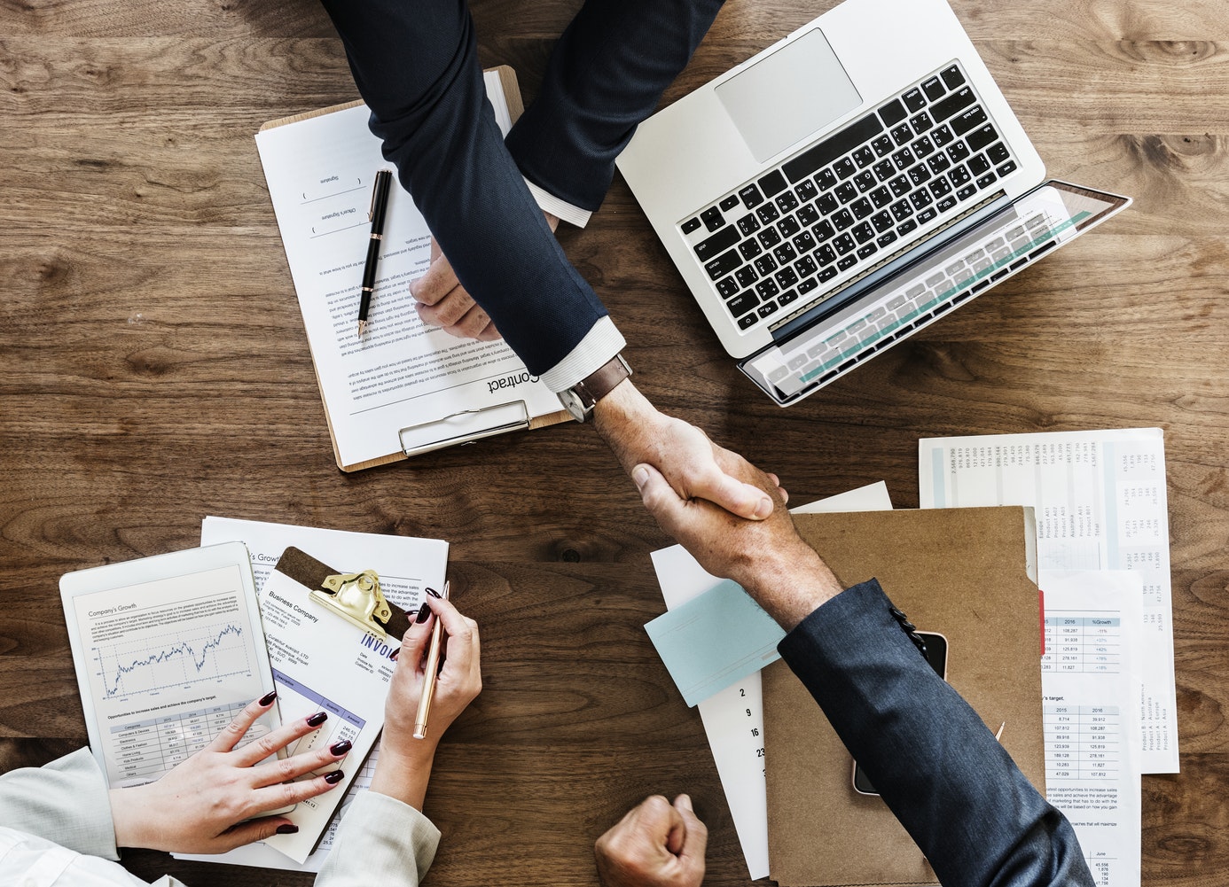 Business team reviewing records around a work table