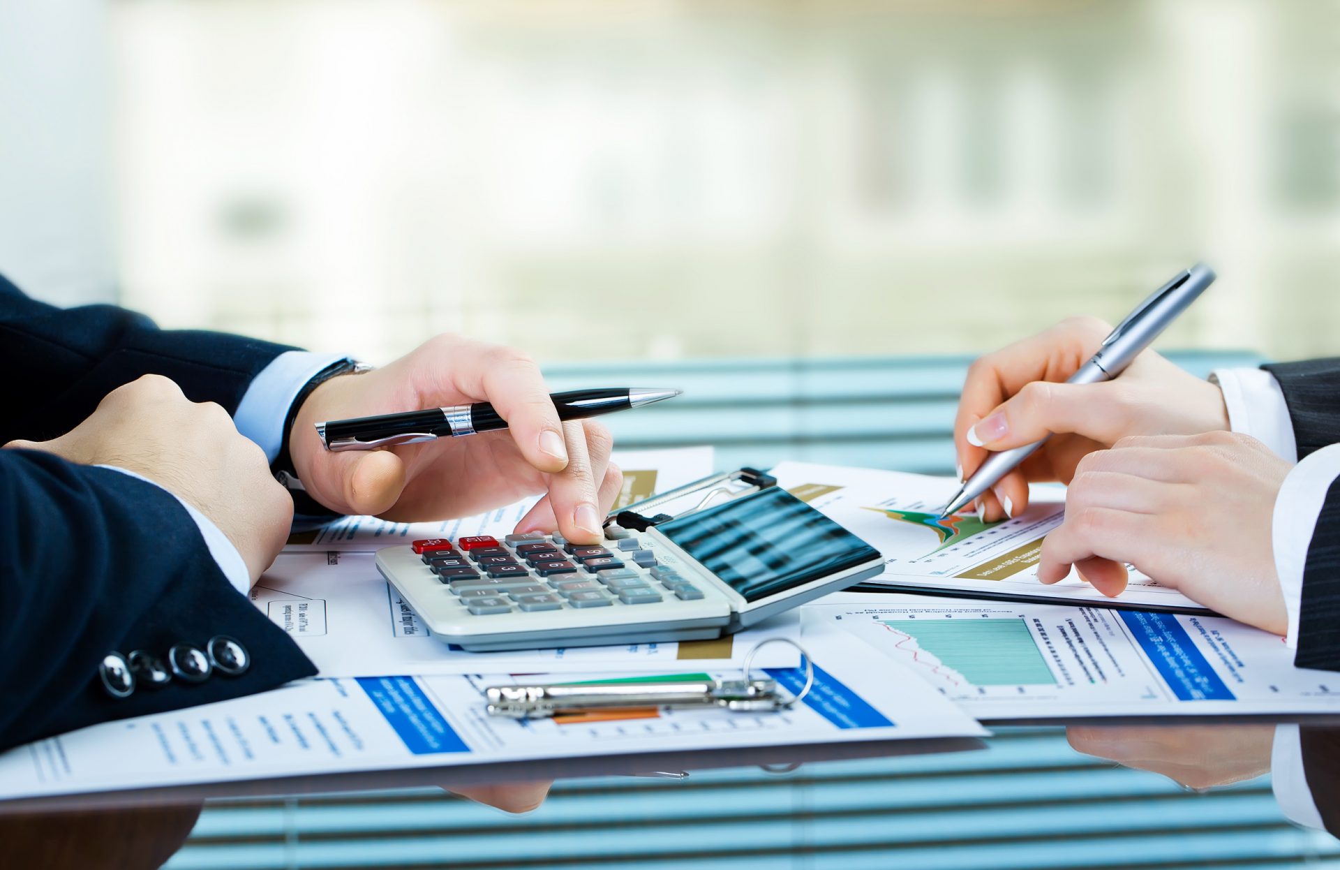 Calculator and financial charts used for tax preparation